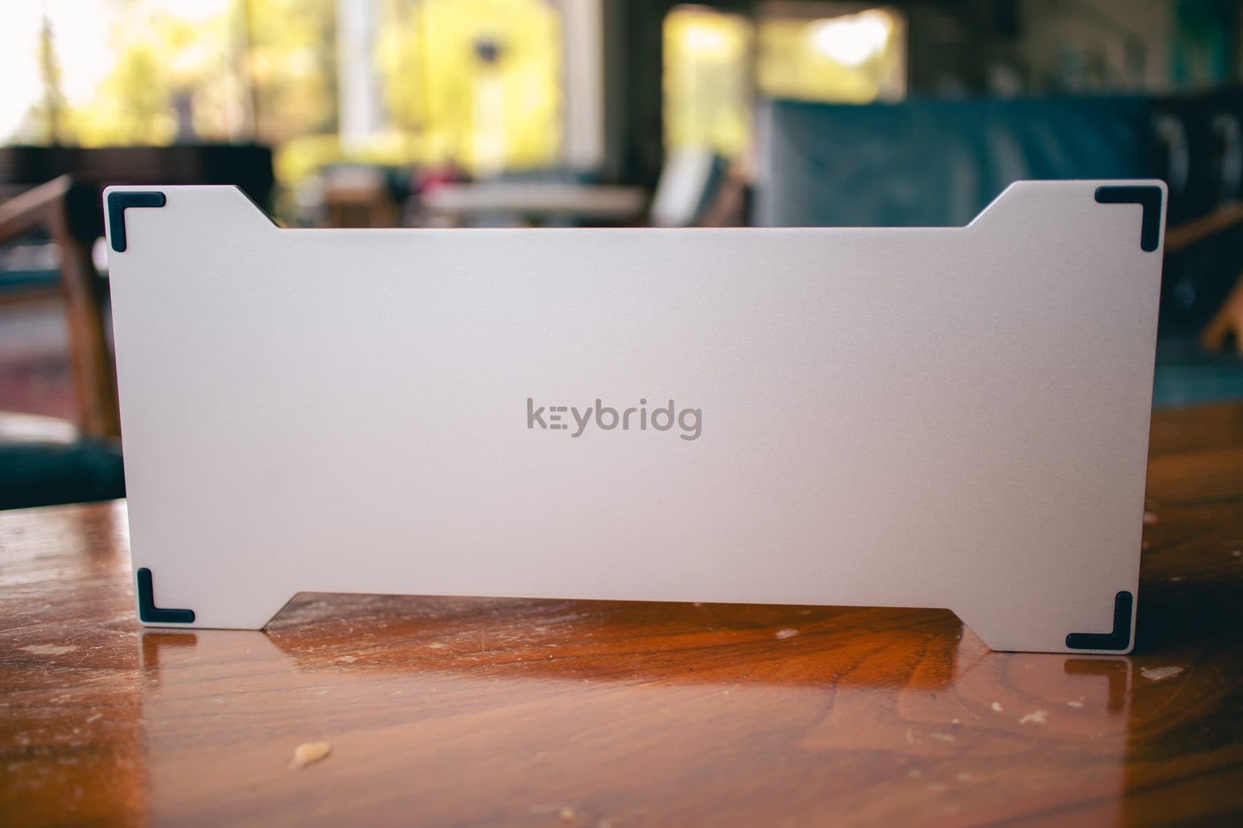 keybridg machined aluminium keyboard bridge resting across a laptop keyboard